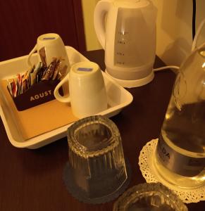 a table with a tray with cups and a blender at Locanda San Felice in San Felice del Benaco
