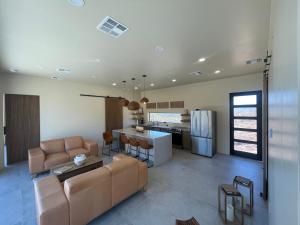 a kitchen and living room with a couch and a table at Desert Rain -Floating House in Anthem