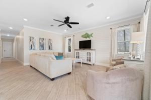 a living room with two couches and a ceiling fan at Beach Please in Gulf Shores +36 photos