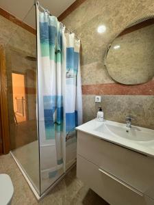 a bathroom with a shower and a sink and a mirror at VILLA CHRIS Ocean View in La Jaca +48 photos