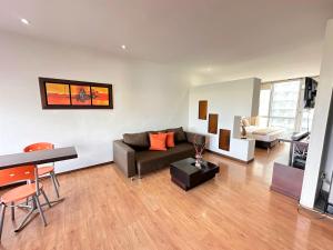 a living room with a couch and a table at M402- Apartaestudio tipo loft en el norte (Av 19) in Armenia +15 photos