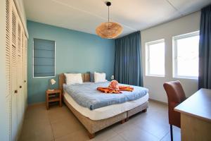 a bedroom with a bed with a towel on it at Blue Emerald Ocean's 8 in Willemstad +38 photos