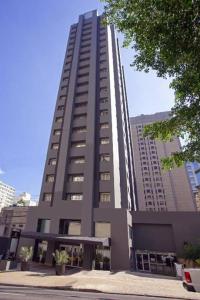 a large tall building in a city at Flat Jardins Paulista 540 in Sao Paulo