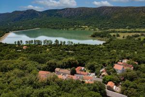 an aerial view of a town and a lake at House Maris in Tribalj