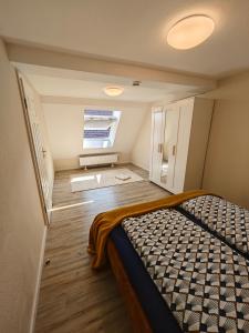 a small room with a bed and a window at Villa Vanilla im Burgdorf 11 P. in Neidenstein