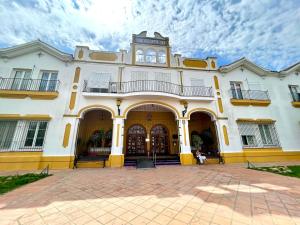 a large white building with a large courtyard at Piropos de Doñana in El Rocío