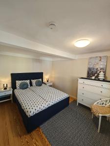 a bedroom with a bed and a dresser at Villa Vanilla im Burgdorf 11 P. in Neidenstein