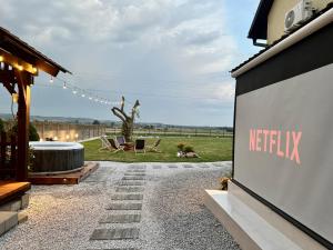 a backyard with a netflix sign on the side of a building at Agroturystyka Gorajeckie Roztocze in Górajec Zastawie