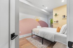 a bedroom with a bed and a wall mural at Central DC 5-BR Townhome - Walk to METRO-rail in Washington, D.C.