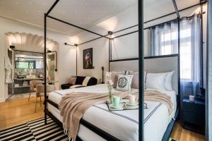 ein Schlafzimmer mit Himmelbett und ein Wohnzimmer in der Unterkunft UTOPIC Campos Elíseos by ULIV in Mexiko-Stadt