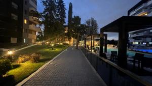 a walkway next to a swimming pool at night at Guesthouse Luxury in Córdoba
