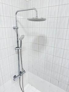 a shower with a shower head in a bathroom at The Pearl - Cascais Guest House - City & Beach in Cascais