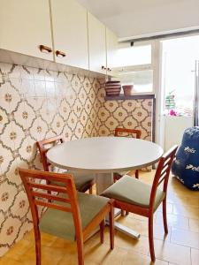 a kitchen with a white table and chairs and a table and chairs at The Pearl - Cascais Guest House - City & Beach in Cascais