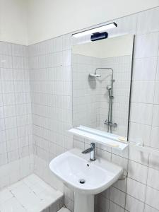 a white bathroom with a sink and a shower at The Pearl - Cascais Guest House - City & Beach in Cascais +31 photos