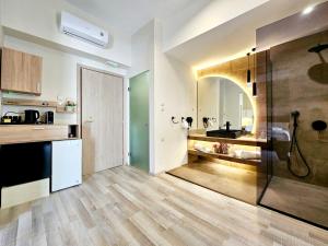 a kitchen with a sink and a shower in a room at Golden City Center Suites in Rhodes Town