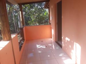 an empty room with a window and a tiled floor at Sítio Do Sossedo in Itacaré +4 photos