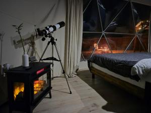 a camera on a tripod in a room with a bed at White Camel in Kanab +27 photos