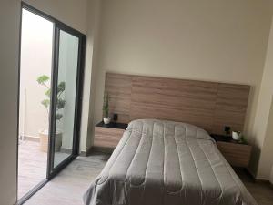 Ένα ή περισσότερα κρεβάτια σε δωμάτιο στο Edificio