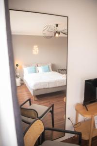 a reflection of a bedroom with a bed and a mirror at Apartments Strauss near BS-Hauptbahnhof in Braunschweig