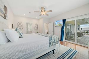 a bedroom with a bed and a ceiling fan at The Yellow House North at Herons Walk in Pensacola +58 photos