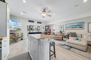 a kitchen and living room with a ceiling fan at The Yellow House South at Herons Walk in Pensacola