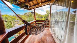 a hammock on the balcony of a tree house at Sunset Beach in Barra Grande