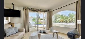a living room with a couch and a large window at Casa Al Castello - Apartments Buccino in Buccino