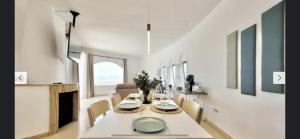 a white dining room with a table and chairs at Casa Al Castello - Apartments Buccino in Buccino