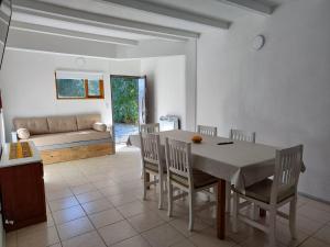 a dining room with a table and chairs and a couch at Sol de montaña, Bariloche. in San Carlos de Bariloche
