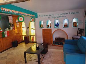 a living room with a blue couch and a table at Hacienda del Indio in Mexicali +36 photos