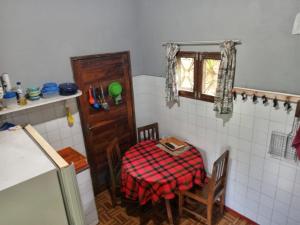 a small kitchen with a table and a window at Hostel Pensão Ya Mute in Chimoio