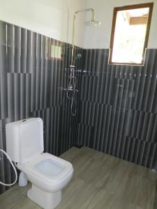 a bathroom with a toilet and a shower at Chamodya Home Stay in Ella