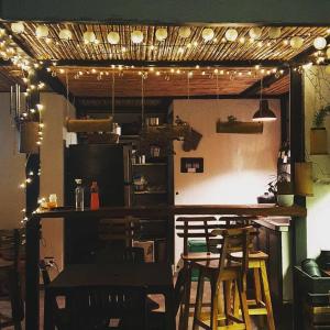 a kitchen with a bar with chairs and lights at Apartamento Industrial tipo Loft in Circasia +14 photos