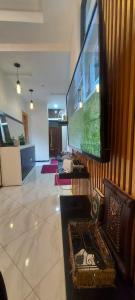 a living room with a large flat screen tv at Appartement meublé in Ville Nouvelle