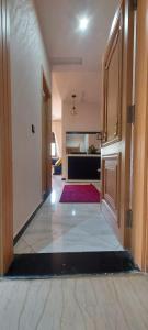 a hallway of a house with a room with a door at Appartement meublé in Ville Nouvelle
