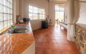 a kitchen with a sink and a tile floor at Sky Temple Yelapa in Yelapa