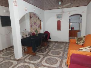 a living room with a table and a couch at Alojamiento Juana in Puerto Iguazú