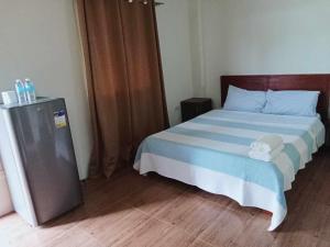 une chambre avec un lit avec une couette bleue et blanche dans l'établissement Panglao Haven, à Panglao