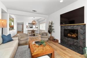 a living room with a couch and a fireplace at Pacific Passion Beach House in Carlsbad