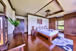 a bedroom with a white bed and a vase at Villa Seven Swifts - Bangrak Ocean View in Bophut  +37 photos