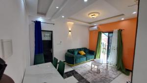 a living room with a couch and a table at ResidenceGermanotech VIP 2e, internet 2 balcons internet gardien menagere sur place in Douala