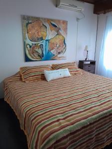 a bedroom with a bed with a laptop on it at La Escondida in San Antonio de Areco +31 photos