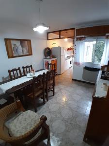 a kitchen and dining room with a table and chairs at La Escondida in San Antonio de Areco