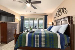 a bedroom with a bed and a ceiling fan at Little House on the 12th Hole - Luxury Golf Condo in Branson +24 photos