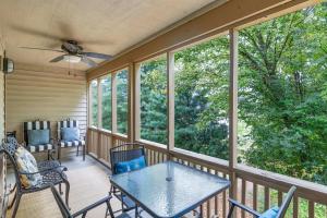 a screened in porch with a table and chairs at 2 Bd 2 Bath Indoor Outdoor Pool Hot tub in Branson
