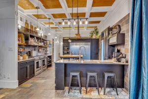 a large kitchen with a large island with bar stools at Bare Feet Beach House Close to beach dog friendly in Gulfport