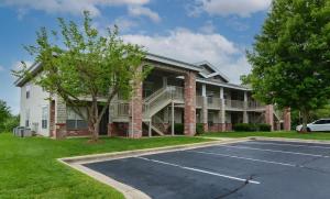 a large house with a parking lot in front of it at Tuscany Villas - In the heart of Branson in Branson