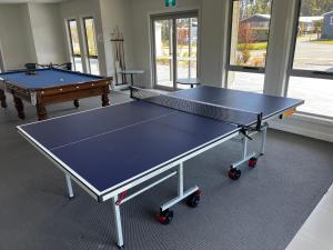 two ping pong tables sitting in a room with at Basin Breeze Retreat Private House with Shared Pool in St Georges Basin
