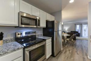 a kitchen with a stove and a refrigerator at Glam R Us - Pool - Fabulous Location Must Stay in Branson