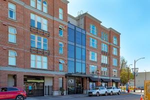 a large brick building with cars parked in front of it at Sleek Kitchen Island And Garden Views in Victoria